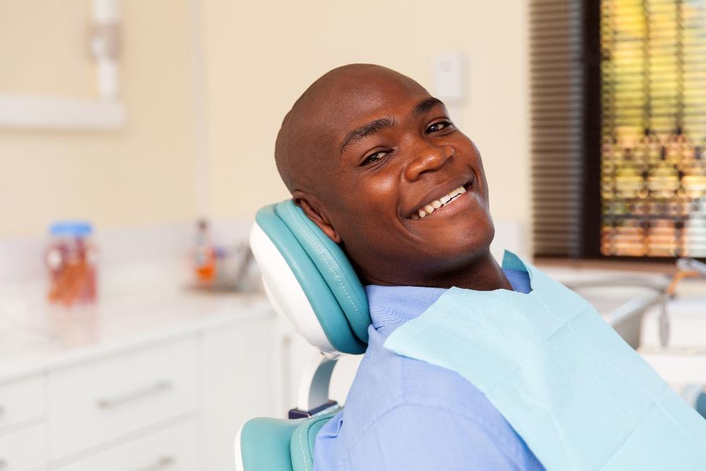 man smiling in dental exam chair l dentist in smyrna ga