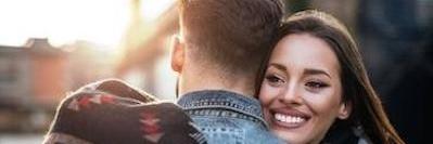 young couple hugging outside | best dentist smyrna