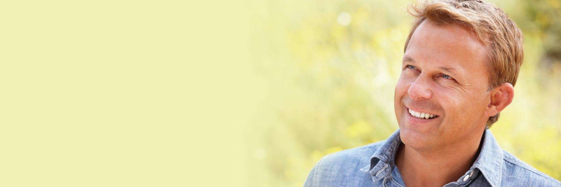 A man with blonde hair smiling