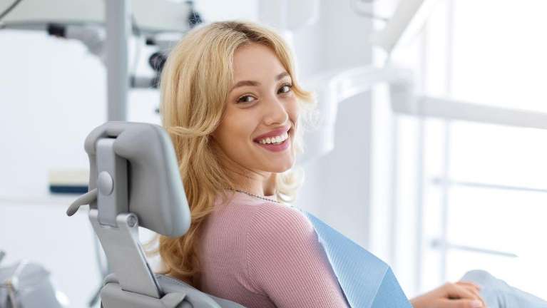 woman in dental chair smiling | Dentist Smyrna, GA