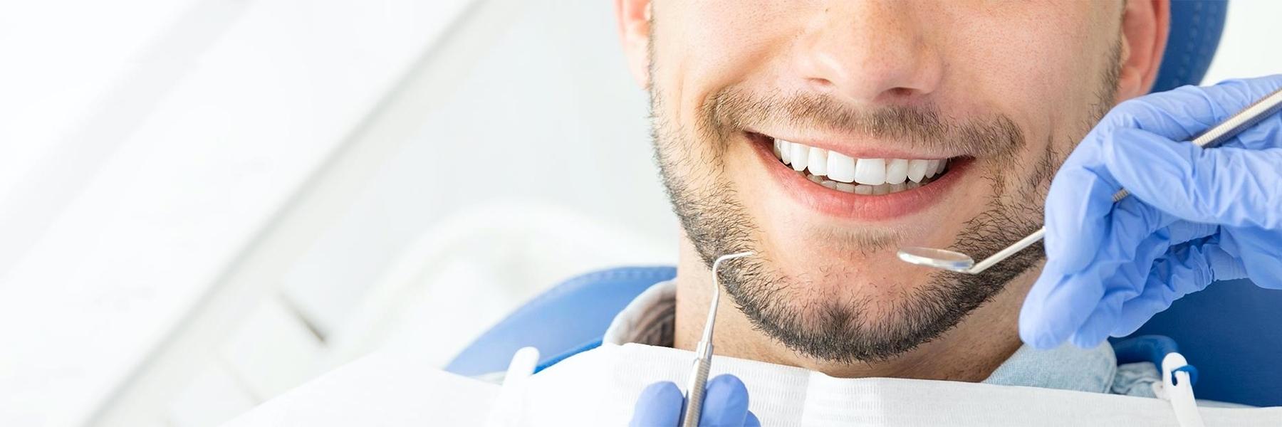 man receiving dental exam | tooth extraction smyrna ga