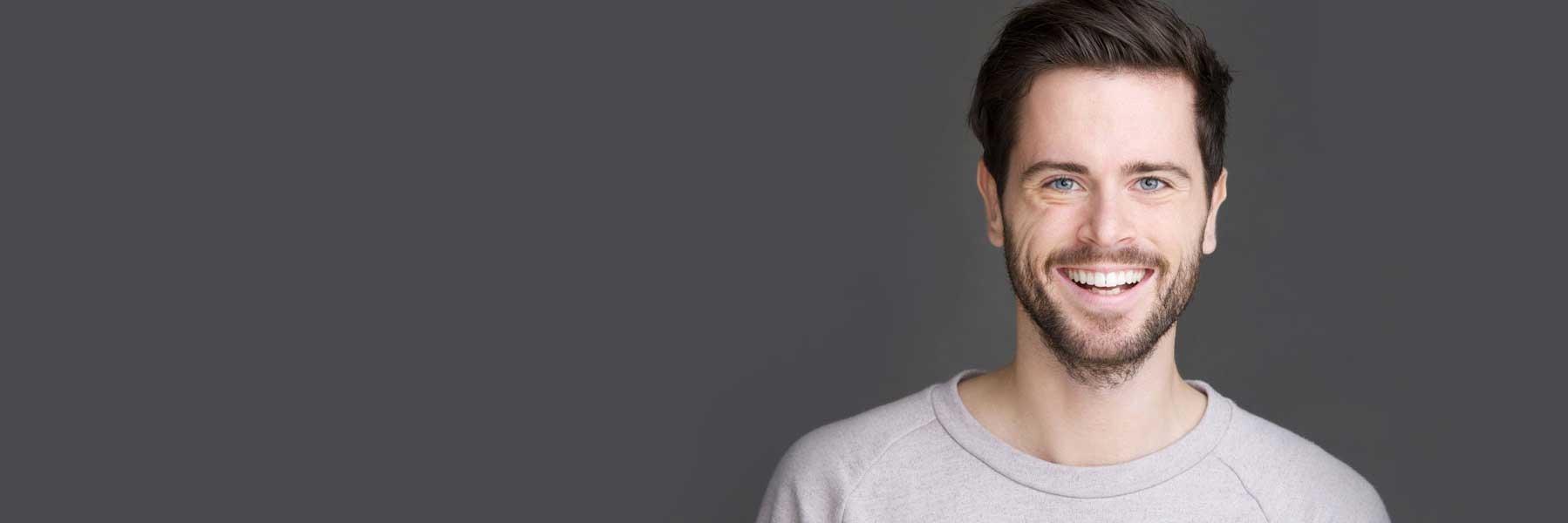 man with dark hair smiling l emergency dentistry smyrna ga