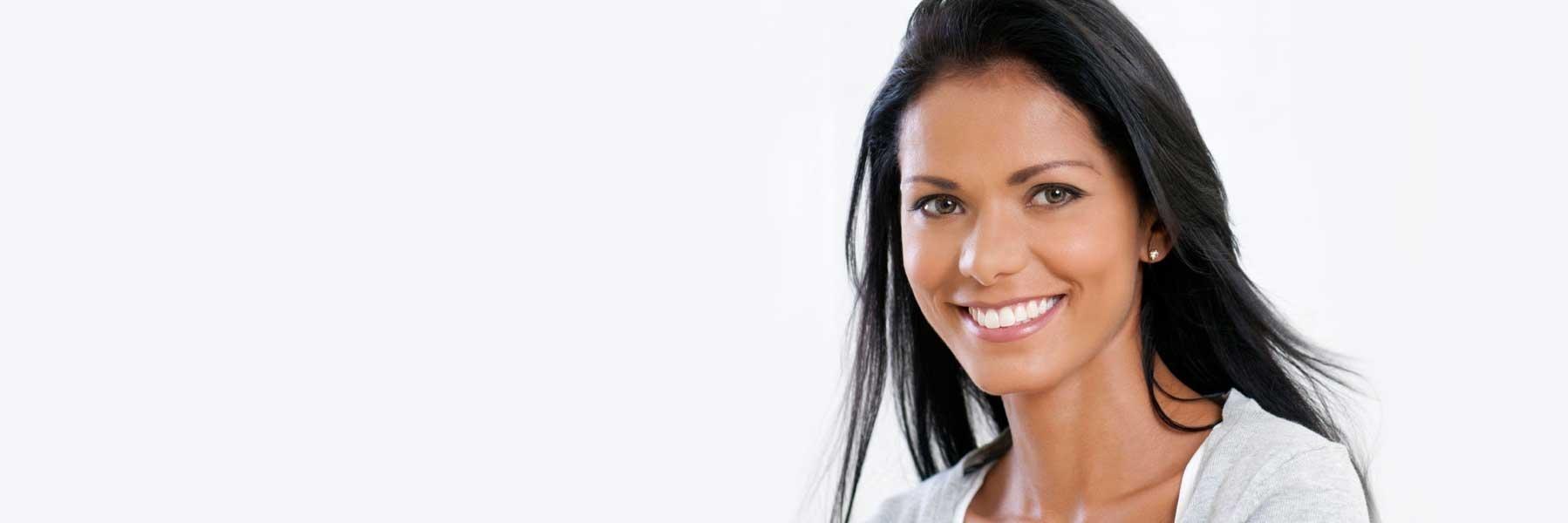 Young woman smiling with brown hair l Root Canal Therapy Smyrna, GA